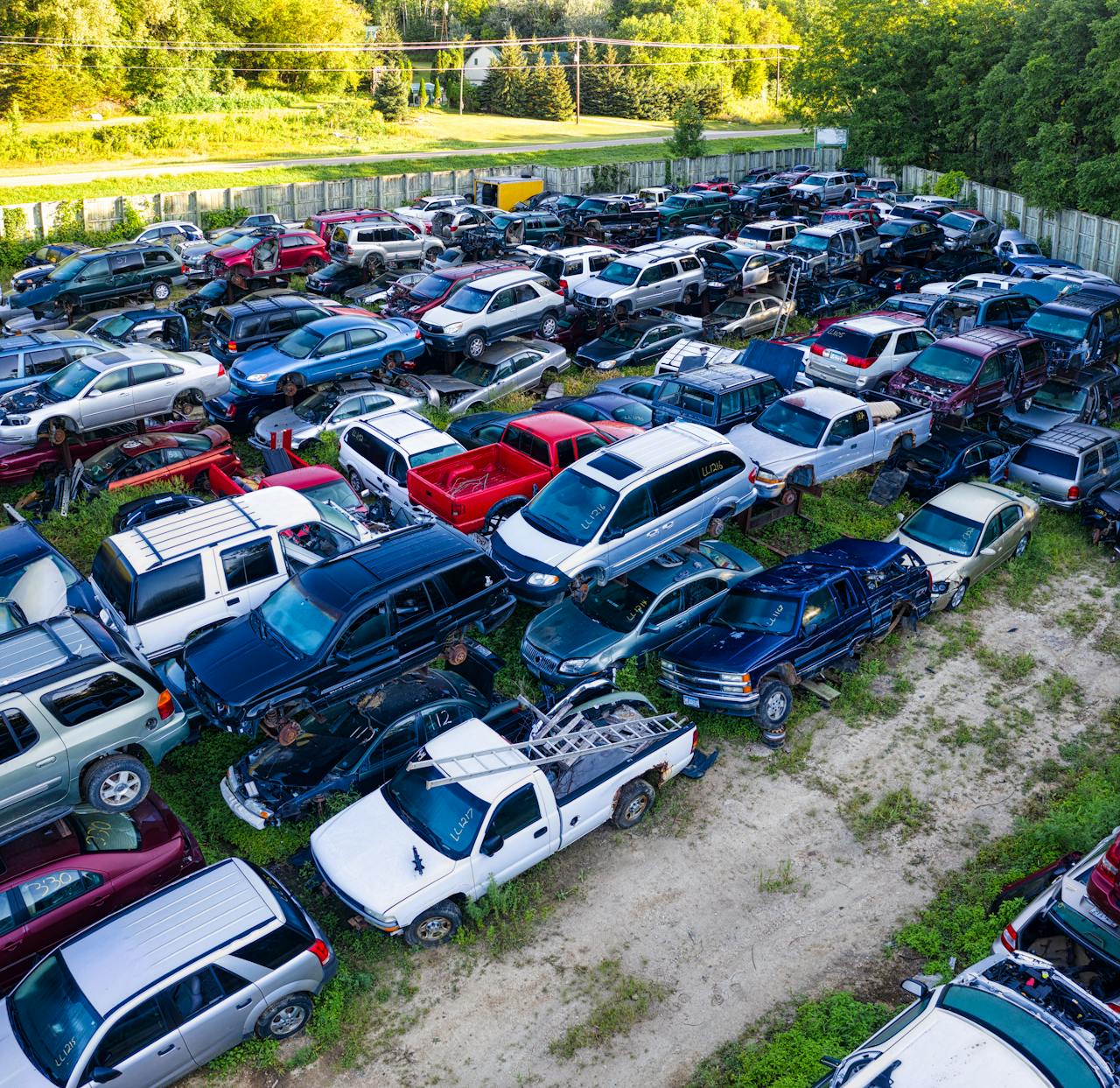 Aerial shot of a vehicle junkyard with rows of parked, damaged cars in Red Wing, Minnesota.